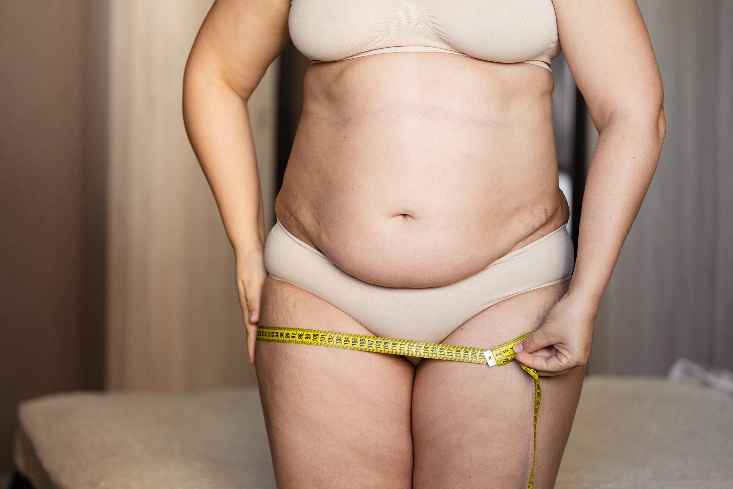 fat-and-unrecognizable-woman-measures-hips-with-me-2023-11-27-05-30-00-utc